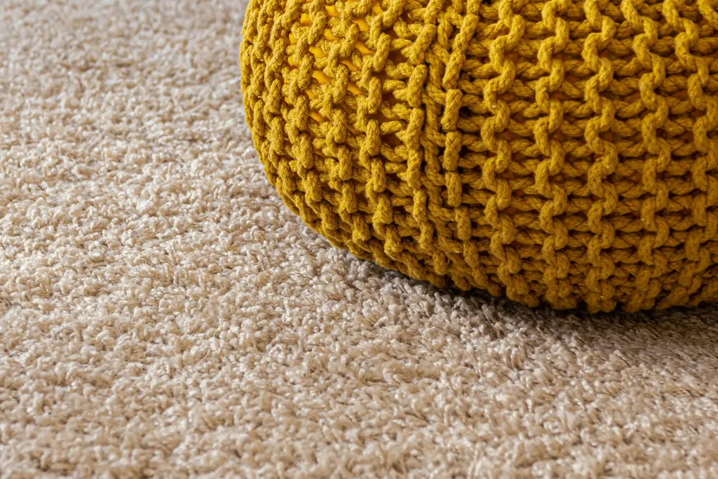 Soft carpet weave texture in warm neutral tones — illustrative material reference only